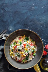 Rice salad with tuna and vegetables. Top view with copy space. Healthy food.