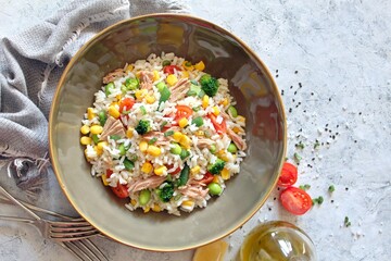 Rice salad with vegetables and tuna. Top view with copy space. Healthy food.