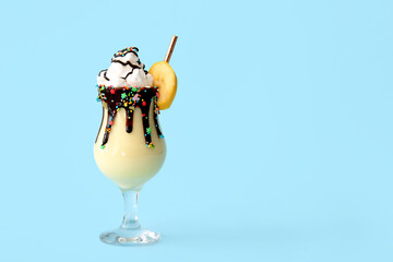 Glass of tasty banana milkshake on color background