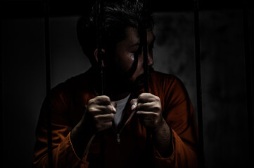 Asian man desperate at the iron prison,prisoner concept,thailand people,Hope to be free,Serious...