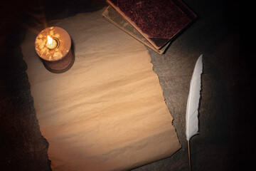 Obraz na płótnie Canvas old sheet of paper, candle lit, quill pen, vintage desk, top view, space for text
