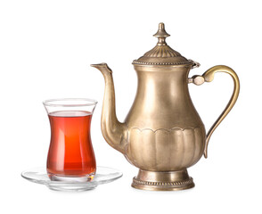 Glass and teapot of tasty Turkish tea on white background