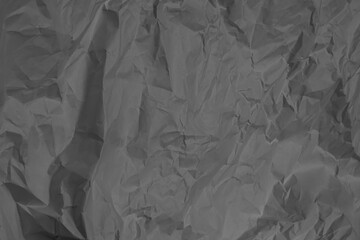 Crumpled paper in dark color as a background.