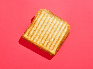 Toasted sandwich on pink background, from above, hard shadow