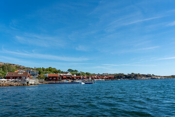 Fototapeta na wymiar Swedish Houses On The Harbour and Flag.