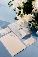 wedding invitation in a blue envelope on a table