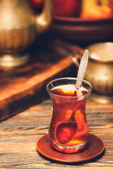 Glass of tasty Turkish tea on wooden background