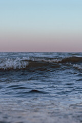small sea waves in the sea on a clear warm day. Summer vacation near the water