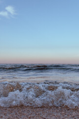 small sea waves in the sea on a clear warm day. Summer vacation near the water