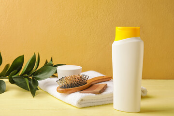 Composition with bottle of shampoo on color background