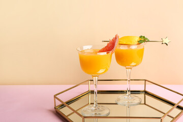 Tasty mango cocktails on color background