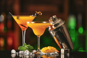 Tasty mango cocktails on table in bar