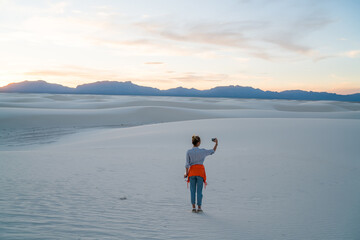 Traveling woman taking selfie in nature