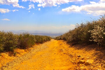 Beautiful Hiking Trail On a Sunny Day with Mountains and Clouds