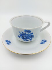 Vintage soviet cup and plate with flowers on white background.