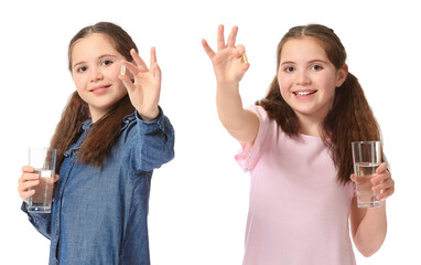 Little twin girls with fish oil on white background