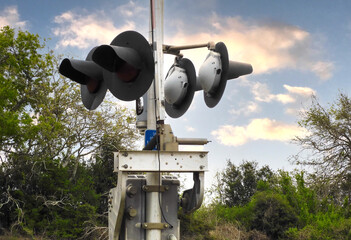 Railroad crossing signals near brush