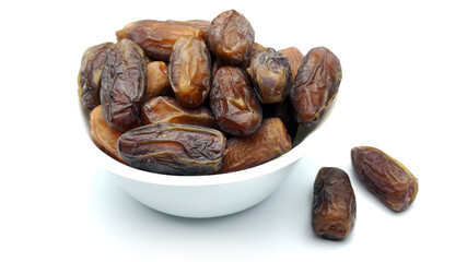 A bowl of dates fruit in white background. Ramadan Conceptual photo.
