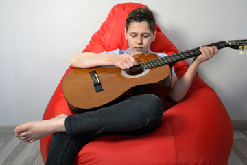 close up boy playing the guitar © Cavan