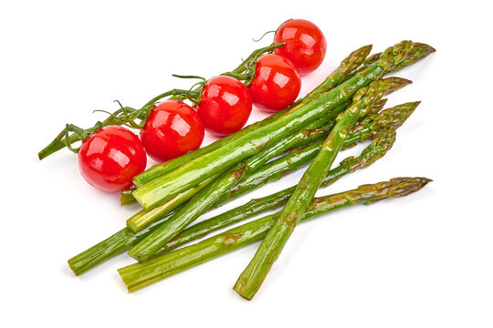 Fresh organic asparagus with cherry tomatoes, healthy food, isolated on white background. High resolution image