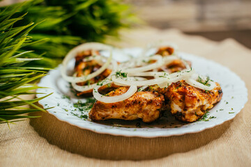 grilled wings with onions on a plate