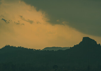 The light of the sun is setting along the mountains and fertile forests at Klong Phawa Yai Reservoir, Kaeng Hang, Chanthaburi, Thailand.