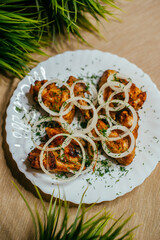 grilled wings with onions on a plate