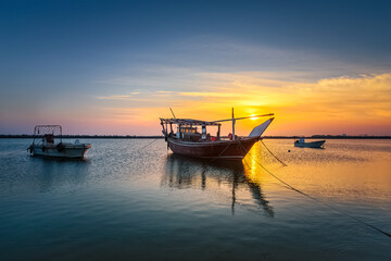 Fototapeta na wymiar Boats on Dammam sea side with sunrise background view. Dammam, Saudi Arabia.