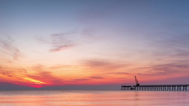 Time lapse with colorful close up view of a sandy beach at sunrise. Dramatic sea sunrise, tender pink sky and shining waves