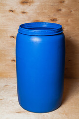 Plastic barrel stands on wooden background