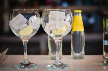 two ice glasses of gin and tonic on the table