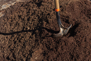 shovel buried in a pile of earth to work the rural field