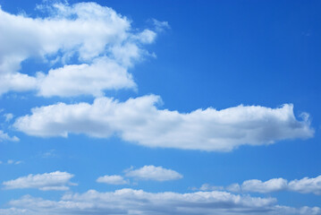 Afternoon white  clouds and clear blue sky background. Peaceful sky in calm atmosphere. 
