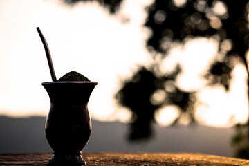 Chimarrão, a traditional Brazilian yerba mate tea. Typical South American drink with Serra Gaúcha in the background