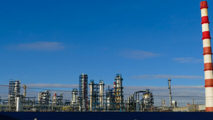 Fototapeta na wymiar Corps of Moscow refinery in spring in clear weather