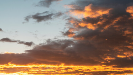 Sunset sky with dramatic orange clouds. Nature sky clouds background.
