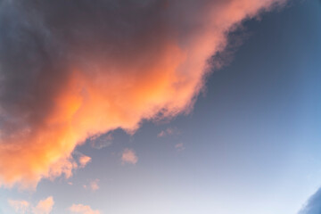 Sunset sky with dramatic orange clouds. Nature sky clouds background.
