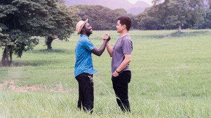 Concept of best friends,African man and asian man handshake with smile and happy