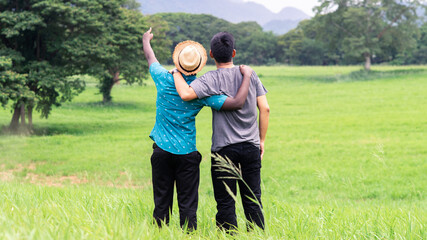 Two traveler men hugging and looking the view of mountain . Concept of best friends