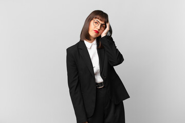 young businesswoman feeling bored, frustrated and sleepy after a tiresome, dull and tedious task,...