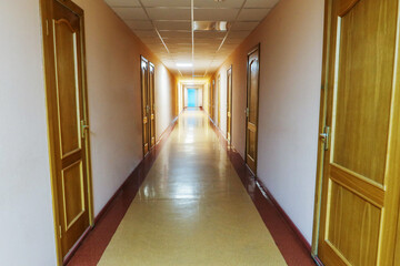 long empty corridor with doors to wards in the hospital