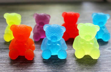 Colorful marmalade bears on a wooden background.
