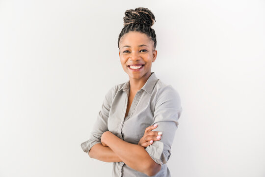 Smiling african american business woman with folded arms Isolated over white background