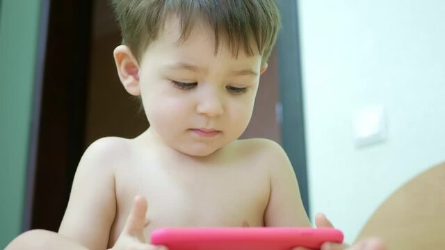 Cute little boy watching cartoons on the phone