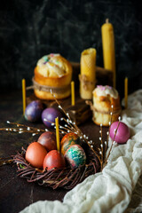 Beautiful Easter cake, candles, willow branches and painted eggs as a symbol of Easter