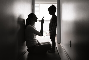 Mother at home correcting, disciplining her child for bad behavior 