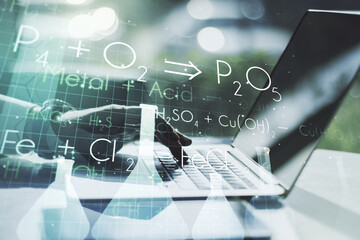 Creative chemistry concept with hands typing on laptop on background. Multiexposure