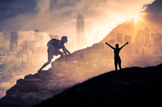 Silhouette of a person climbing to the top of a mountain. Female with arms up to the sky. Strong man, and woman, Winning, success , inspiration and life goals concept. 
