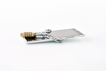  The smartphone is wrapped in a chain and closed with a combination lock. Concept: protection of...