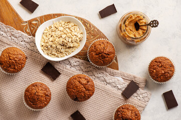 Homemade oat flakes muffins with peanut butter and chocolate.